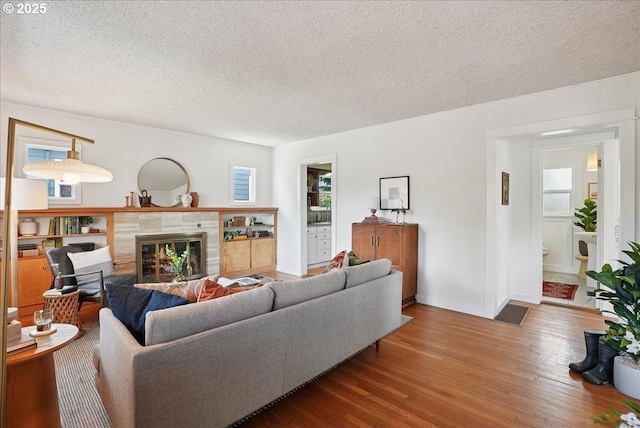 3615 NE 72nd Ave, Portland, OR 97213 - living area featuring a textured ceiling, wood finished floors, and a tile fireplace