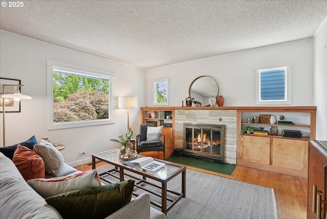 3615 NE 72nd Ave, Portland, OR 97213 - living area featuring wood finished floors, a textured ceiling, and a tile fireplace