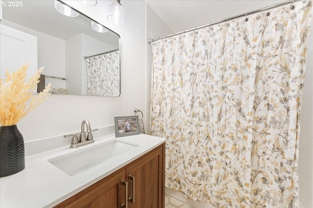 bathroom featuring vanity and curtained shower