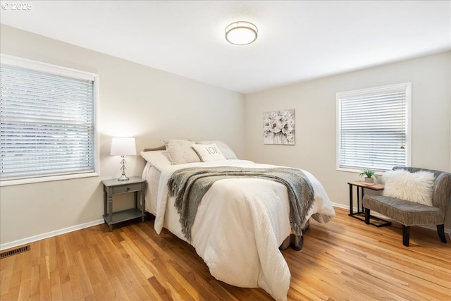 bedroom with light wood-style floors and baseboards