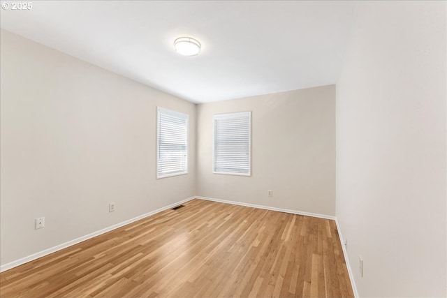 unfurnished room featuring light wood-style floors and baseboards
