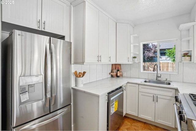 1952 SE 139th Ave, Portland, OR 97233 - kitchen with stainless steel appliances, open shelves, a sink, white cabinetry, and backsplash