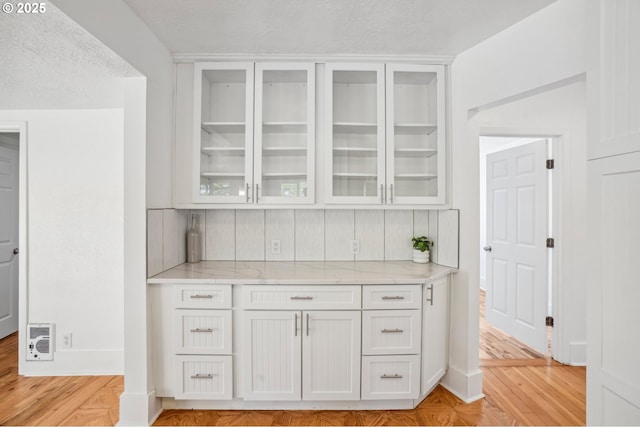 1952 SE 139th Ave, Portland, OR 97233 - bar featuring decorative backsplash, light wood finished floors, heating unit, a textured ceiling, and baseboards