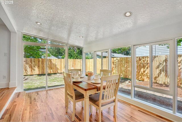 1952 SE 139th Ave, Portland, OR 97233 - sunroom featuring a textured ceiling, plenty of natural light, vaulted ceiling, wood finished floors, and baseboards