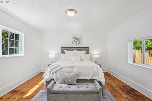 1952 SE 139th Ave, Portland, OR 97233 - bedroom with hardwood / wood-style flooring, crown molding, baseboards, and a textured ceiling