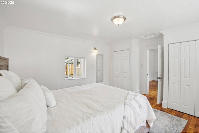 1952 SE 139th Ave, Portland, OR 97233 - bedroom featuring two closets, wood finished floors, crown molding, and attic access