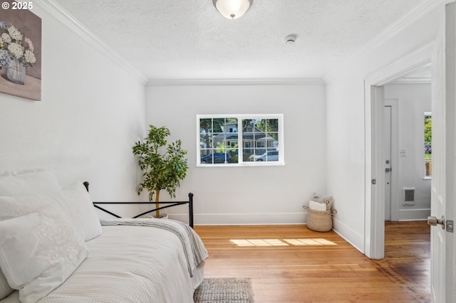 1952 SE 139th Ave, Portland, OR 97233 - bedroom with wood finished floors, crown molding, baseboards, and a textured ceiling
