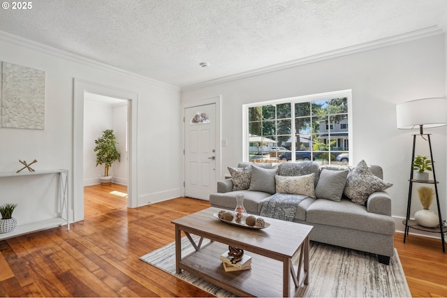 1952 SE 139th Ave, Portland, OR 97233 - living area featuring crown molding, light wood finished floors, a textured ceiling, and baseboards