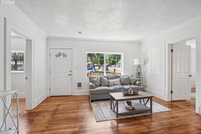1952 SE 139th Ave, Portland, OR 97233 - living area featuring hardwood / wood-style flooring, crown molding, a textured ceiling, and baseboards