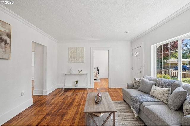 1952 SE 139th Ave, Portland, OR 97233 - living area featuring a textured ceiling, hardwood / wood-style flooring, ornamental molding, and baseboards