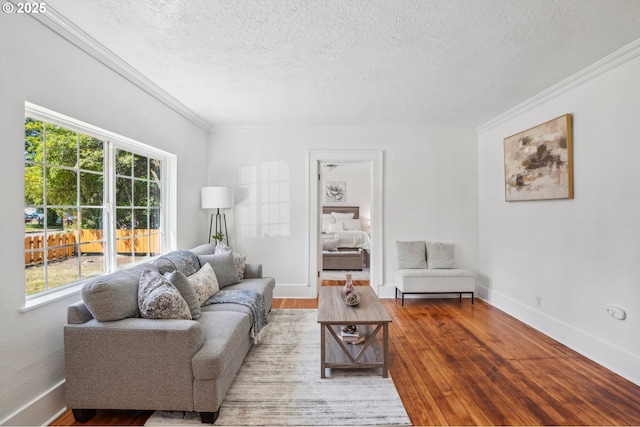 1952 SE 139th Ave, Portland, OR 97233 - living room featuring crown molding, a textured ceiling, wood finished floors, and baseboards