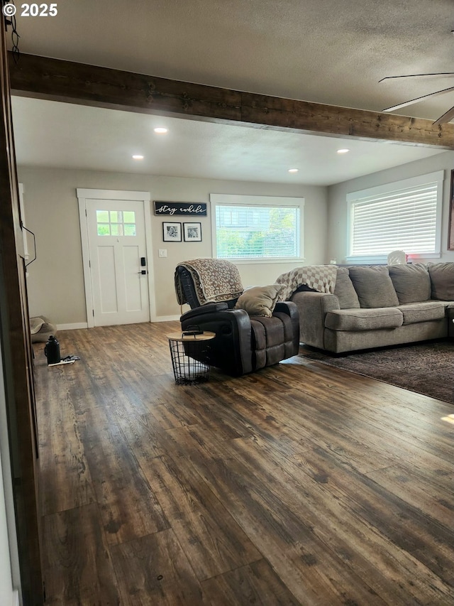 living room featuring beamed ceiling, dark wood-type flooring, healthy amount of natural light, recessed lighting, and a ceiling fan