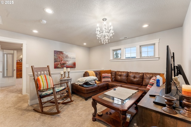 carpeted living room featuring a textured ceiling and an inviting chandelier