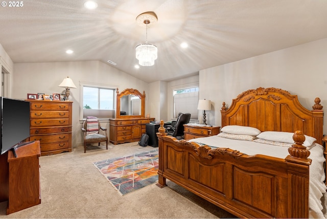 bedroom featuring an inviting chandelier, light colored carpet, and vaulted ceiling