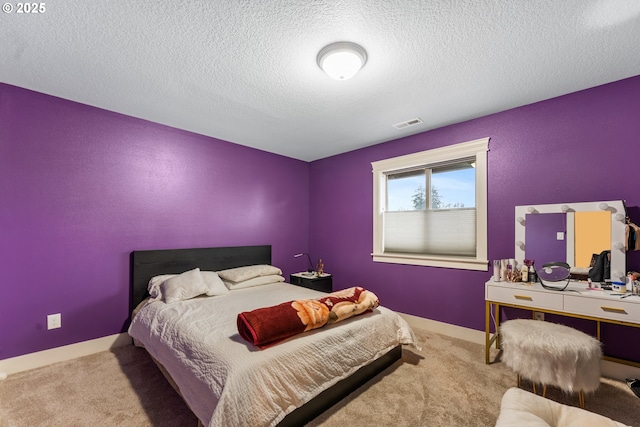 carpeted bedroom featuring a textured ceiling