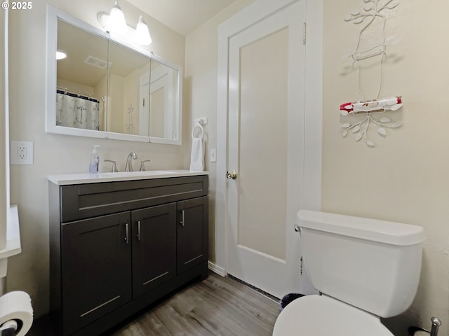 97994 W Benham Ln, Brookings, OR 97415 - full bathroom with wood finished floors, vanity, and toilet
