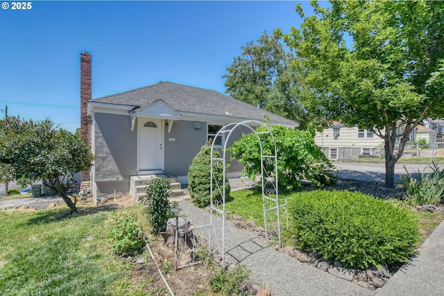 501 NW 6th St, Pendleton, OR 97801 - view of front of property with stucco siding, a shingled roof, and a chimney