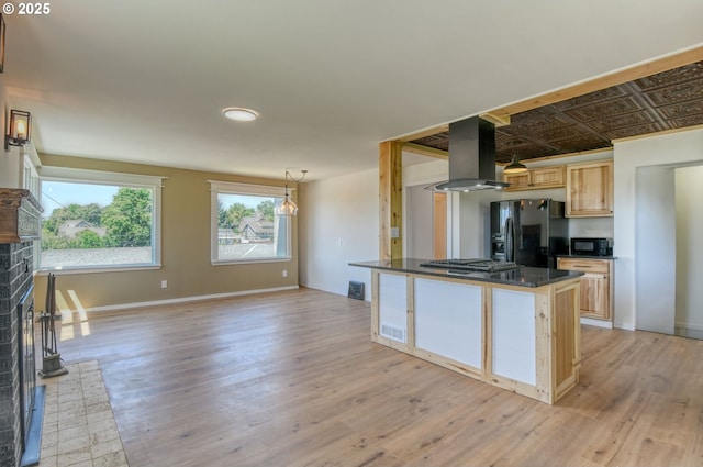 501 NW 6th St, Pendleton, OR 97801 - kitchen featuring black appliances, island range hood, light brown cabinets, dark countertops, and light wood-style flooring