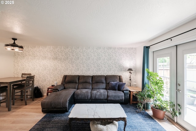 living room featuring wallpapered walls and wood finished floors