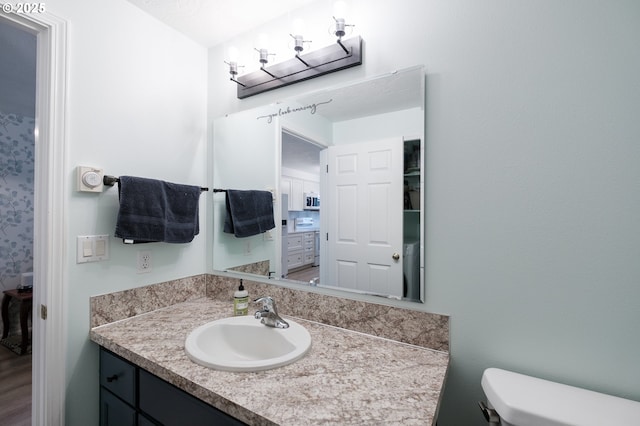 half bathroom featuring toilet and vanity