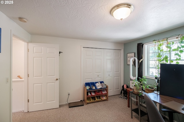 office area with light carpet and a textured ceiling