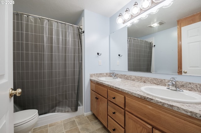 bathroom featuring toilet, double vanity, and a shower with curtain