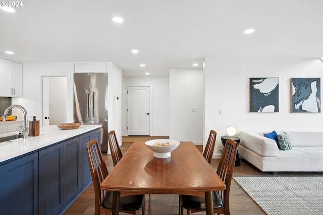 dining space with dark hardwood / wood-style flooring and sink