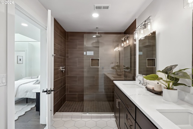 bathroom with vanity and tiled shower