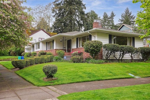 5955 NE 32nd Ave, Portland, OR 97211 - single story home featuring a chimney, brick siding, and a front lawn