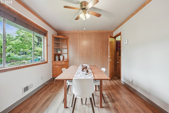 5955 NE 32nd Ave, Portland, OR 97211 - dining area with baseboards, ceiling fan, visible vents, wooden walls, and light wood-style floors