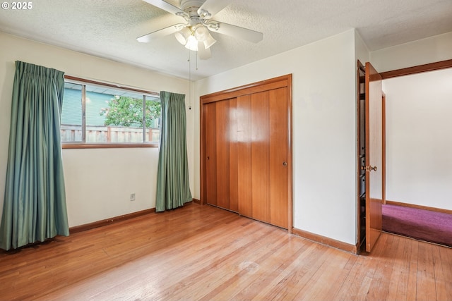 5955 NE 32nd Ave, Portland, OR 97211 - unfurnished bedroom with a textured ceiling, baseboards, and wood-type flooring