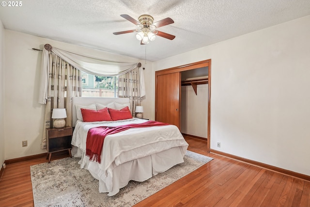 5955 NE 32nd Ave, Portland, OR 97211 - bedroom featuring a closet, wood finished floors, baseboards, and a textured ceiling