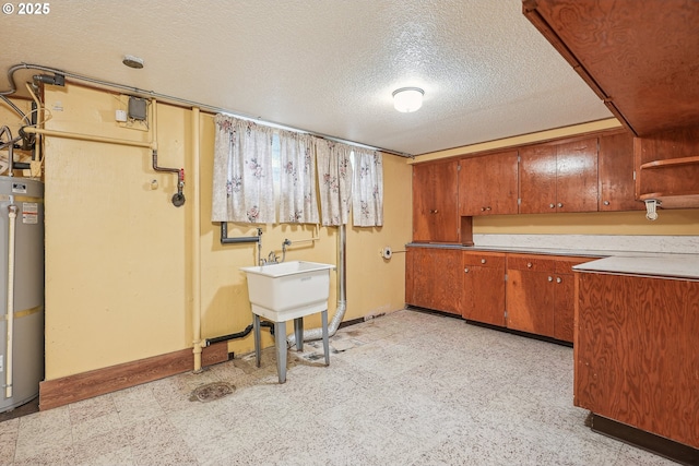 5955 NE 32nd Ave, Portland, OR 97211 - interior space featuring light floors, a textured ceiling, baseboards, gas water heater, and laundry area