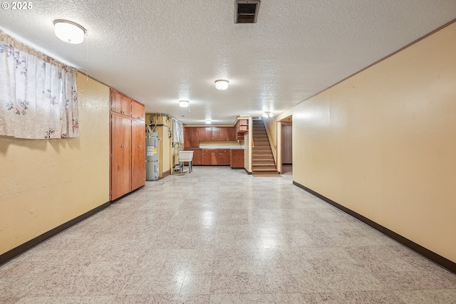 5955 NE 32nd Ave, Portland, OR 97211 - finished below grade area featuring light floors, a textured ceiling, baseboards, stairs, and water heater