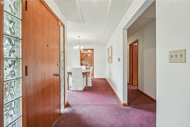 5955 NE 32nd Ave, Portland, OR 97211 - hall with a textured ceiling, baseboards, an inviting chandelier, and carpet