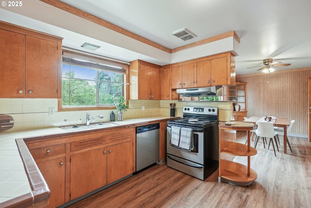 5955 NE 32nd Ave, Portland, OR 97211 - kitchen with tile countertops, under cabinet range hood, visible vents, a sink, and appliances with stainless steel finishes