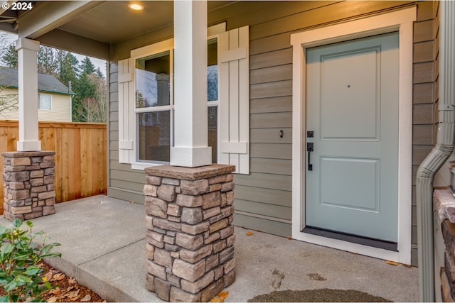 view of exterior entry featuring covered porch