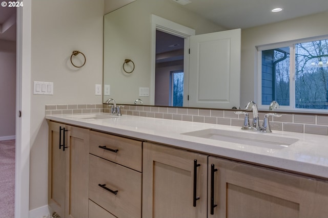 bathroom with vanity and tasteful backsplash