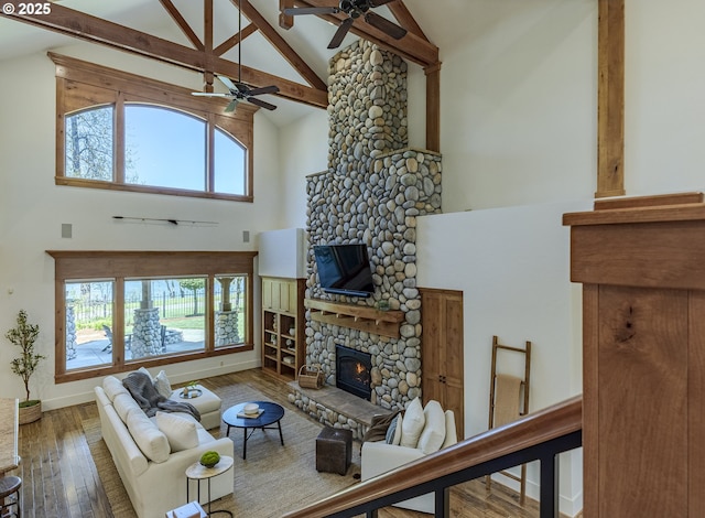 2892 Riverwalk Loop, Eugene, OR 97401 - living area with high vaulted ceiling, beam ceiling, light wood-type flooring, and a stone fireplace