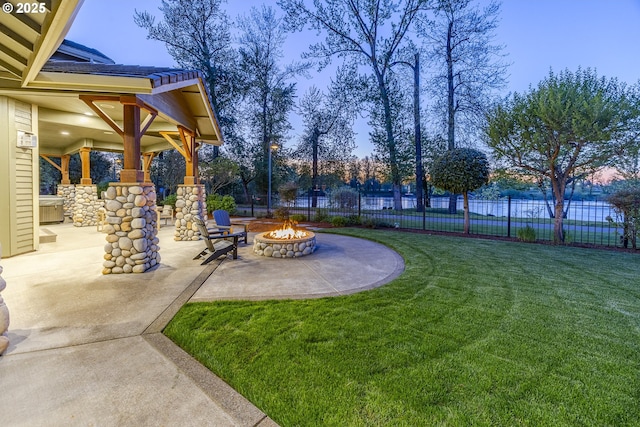 view of yard featuring a patio, fence, and a fire pit