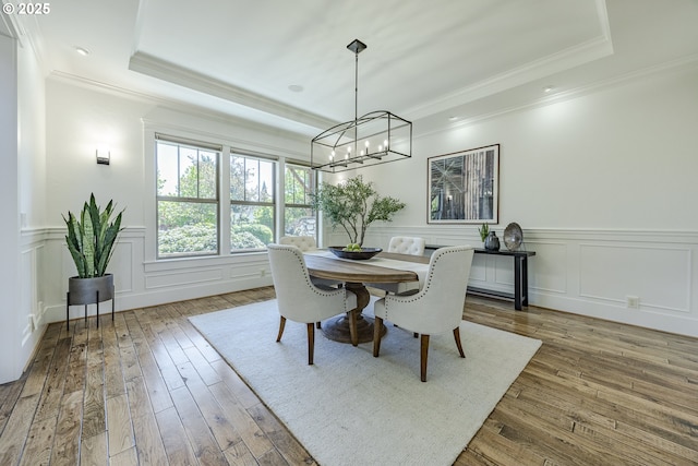 2892 Riverwalk Loop, Eugene, OR 97401 - dining space with a decorative wall, a chandelier, light wood-style flooring, a tray ceiling, and ornamental molding