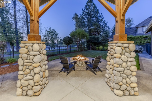 view of patio featuring fence and an outdoor fire pit