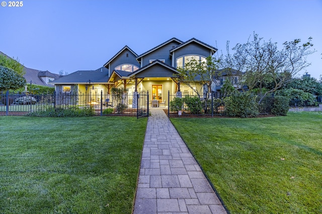 craftsman inspired home with a front lawn and fence