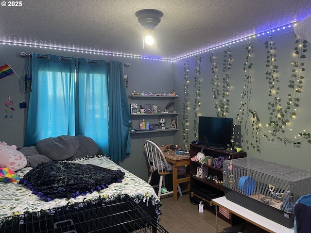 bedroom featuring wood-type flooring and a textured ceiling