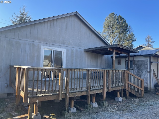 rear view of house with a wooden deck