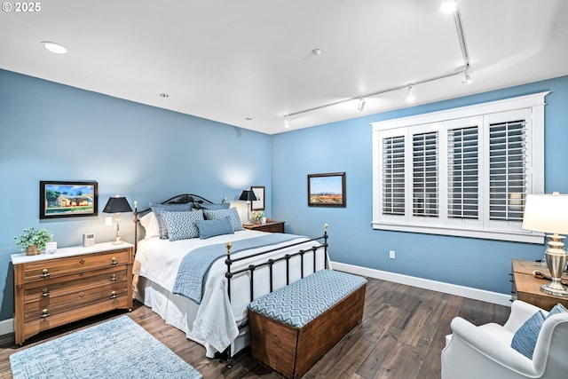 bedroom featuring baseboards and wood finished floors