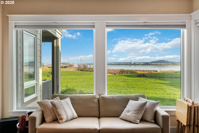 sunroom / solarium with a water view