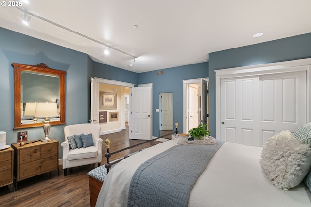 bedroom with dark wood-style floors and baseboards