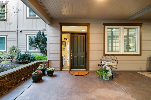 doorway to property featuring a porch and board and batten siding