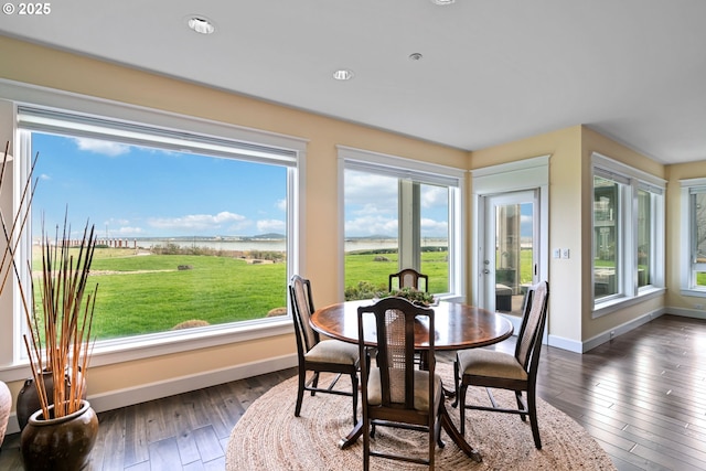 dining room featuring dark wood-style floors and baseboards